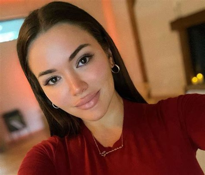 Genesis Lopez boasting her curvacious body in an orange outfit.