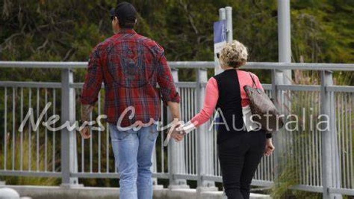 Smith holding hands with his then girlfriend Stella Hudgens.